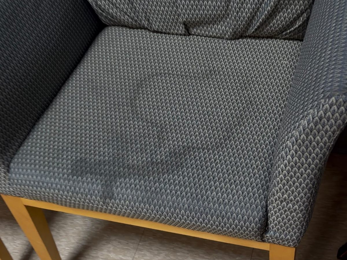 Stain on an upholstered armchair before cleaning
